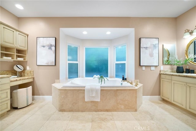 bathroom featuring tile patterned flooring, vanity, and a relaxing tiled tub