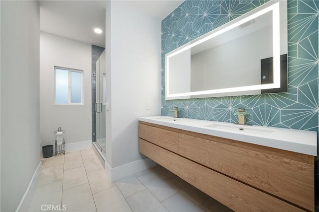 bathroom featuring tile patterned flooring, vanity, walk in shower, and tasteful backsplash