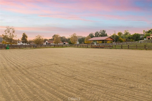 yard at dusk with a rural view