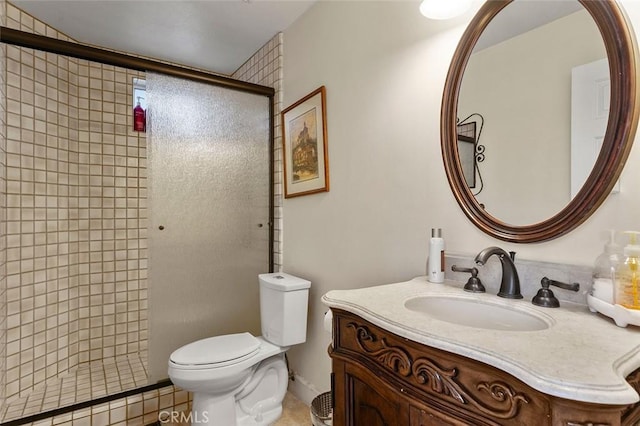 bathroom with toilet, vanity, tile patterned flooring, and a shower with door