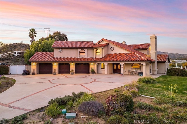 mediterranean / spanish house with a yard