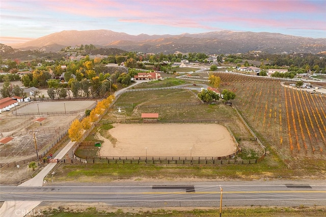 aerial view at dusk with a mountain view and a rural view