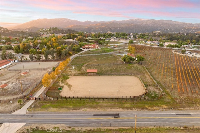 aerial view at dusk featuring a rural view and a mountain view