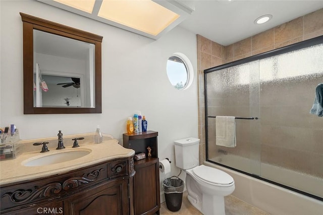 full bathroom with toilet, bath / shower combo with glass door, tile patterned flooring, and vanity