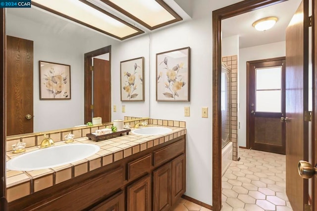 bathroom featuring shower / washtub combination, vanity, and tile patterned floors