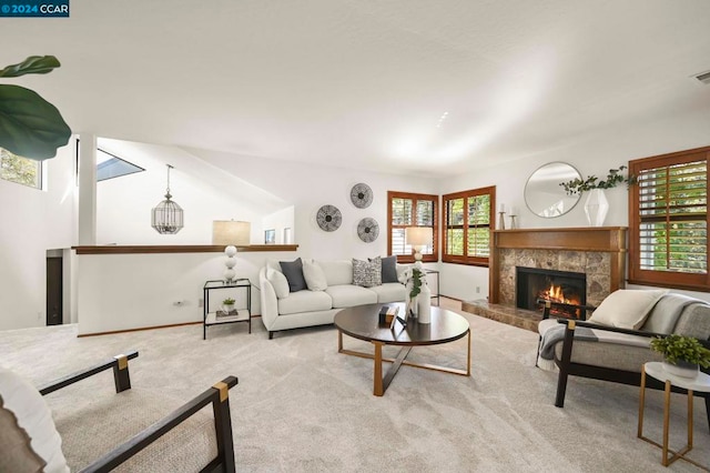 living room with a fireplace, lofted ceiling, and light carpet