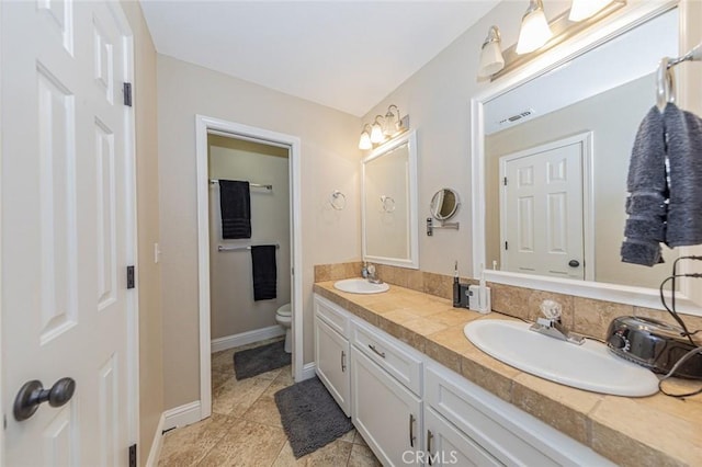 bathroom with vanity, tile patterned floors, and toilet