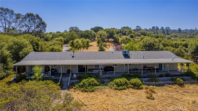 rear view of property with central AC