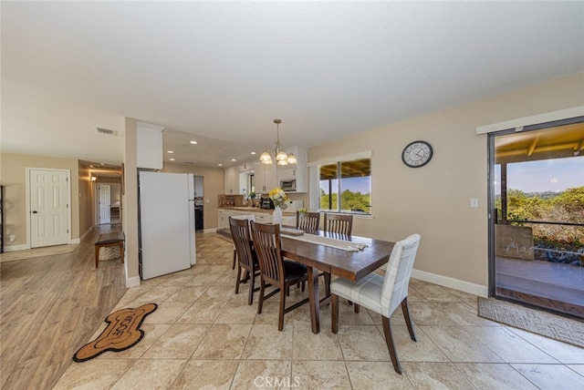 dining space with an inviting chandelier