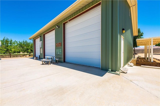 view of side of home featuring a garage and a pergola