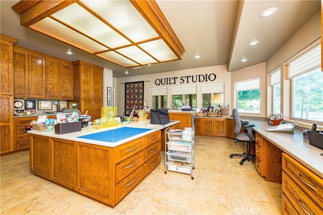 kitchen with a spacious island and built in desk