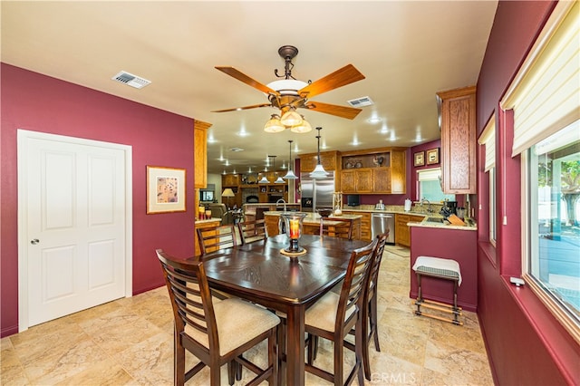 dining area with sink and ceiling fan