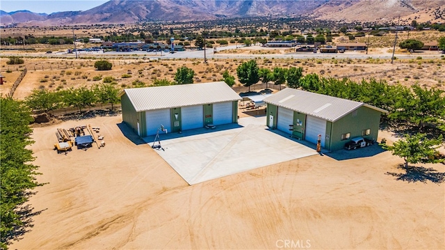 birds eye view of property with a mountain view