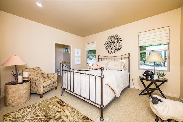 carpeted bedroom featuring multiple windows