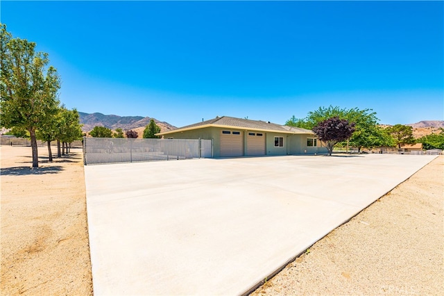 view of front of property with a mountain view and a garage