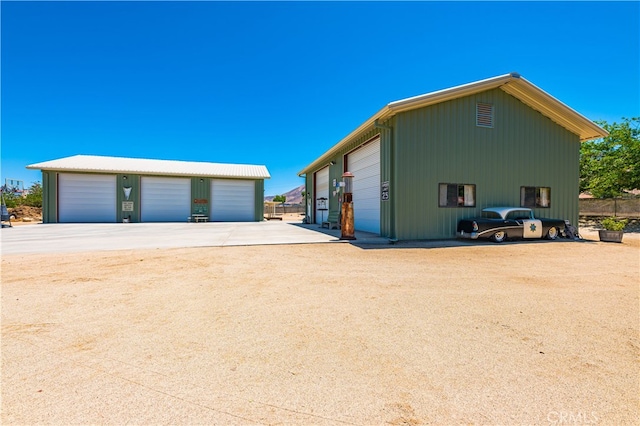 view of home's exterior featuring a garage and an outdoor structure