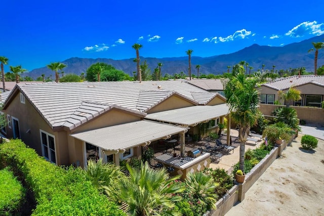 rear view of property featuring a patio area and a mountain view