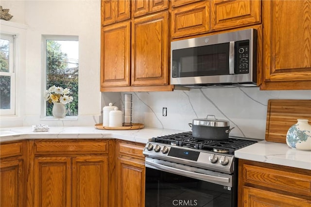 kitchen featuring backsplash and appliances with stainless steel finishes