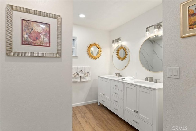 bathroom with wood-type flooring and vanity