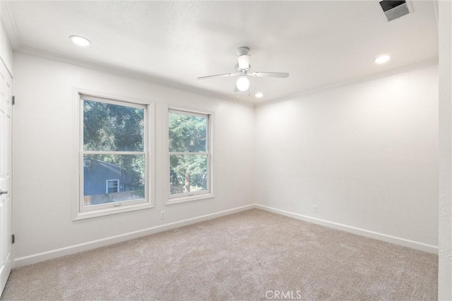 spare room with ceiling fan, ornamental molding, and carpet flooring