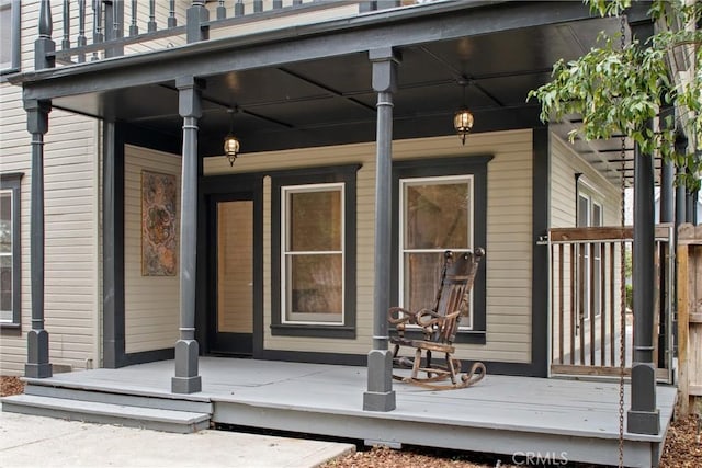 view of exterior entry with a porch