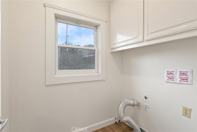 washroom with cabinets, wood-type flooring, and hookup for an electric dryer