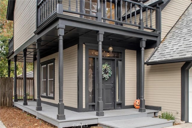 entrance to property with a balcony and a porch