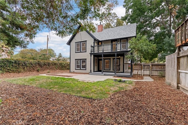 rear view of property with a balcony and a patio area