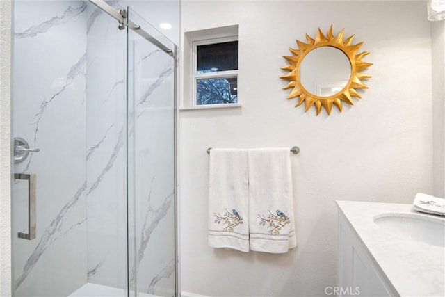 bathroom featuring vanity and a shower with shower door