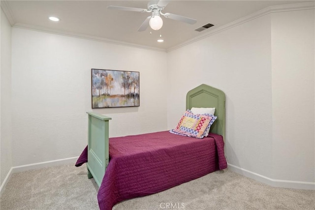 carpeted bedroom with ceiling fan and ornamental molding