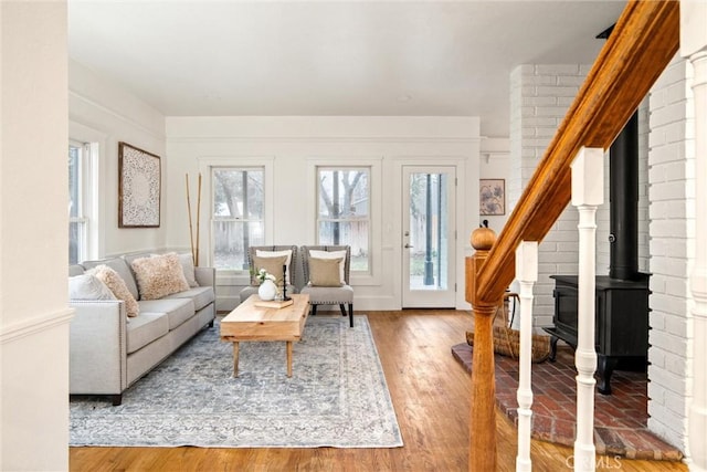 living room with wood-type flooring and a wood stove