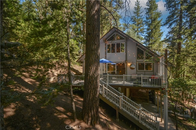 rear view of property with a wooden deck