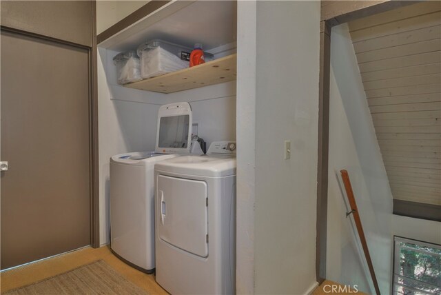 laundry room with separate washer and dryer and light colored carpet