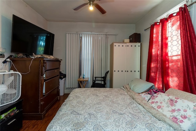 bedroom with ceiling fan and dark wood-type flooring