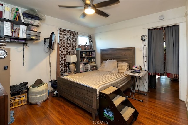 bedroom with ceiling fan and dark wood-type flooring