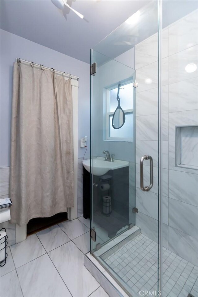 bathroom featuring vanity and a shower with shower door