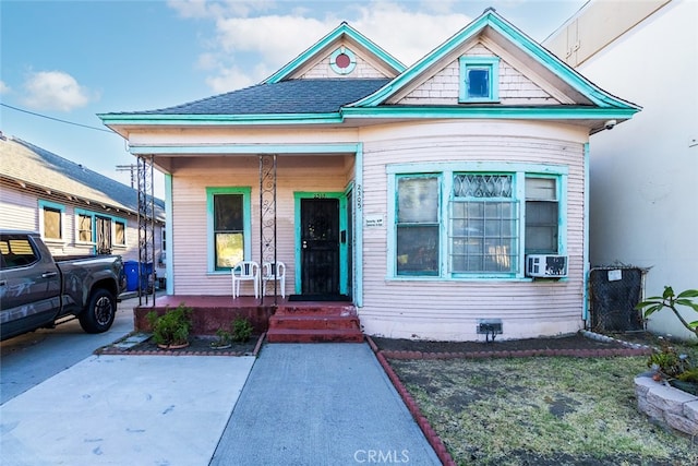 view of front of home with cooling unit and a porch