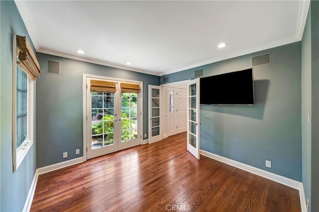 unfurnished room featuring ornamental molding, dark wood-type flooring, and french doors