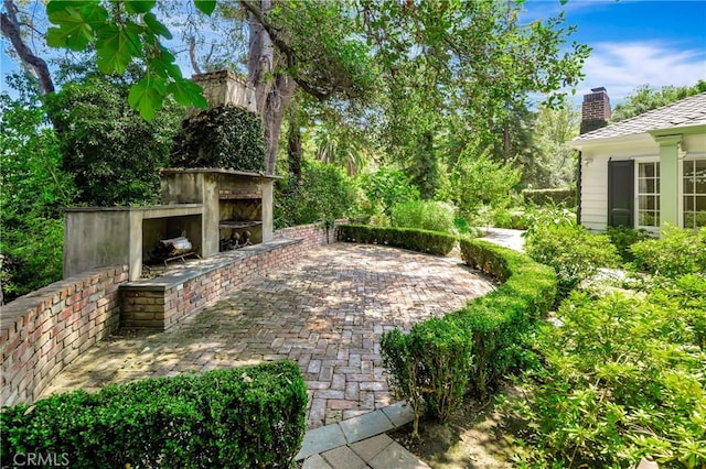 view of patio / terrace featuring an outdoor fireplace