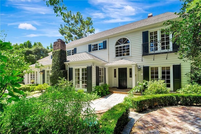 colonial-style house with french doors