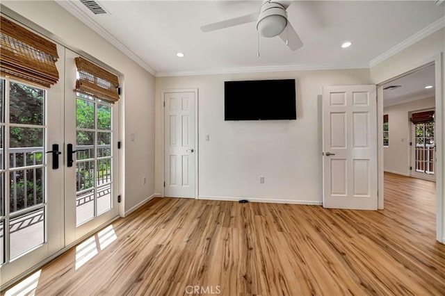 interior space with a wealth of natural light, french doors, crown molding, and light wood-type flooring