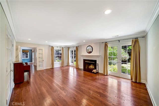 living room with hardwood / wood-style floors, ornamental molding, and french doors