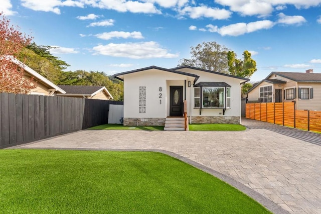 view of front of home with a patio area and a front yard