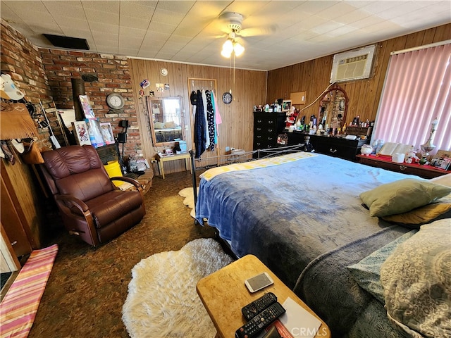 bedroom featuring wooden walls, dark colored carpet, ceiling fan, and a wall mounted air conditioner