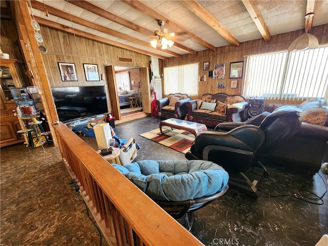 living room featuring wooden walls, beam ceiling, and ceiling fan