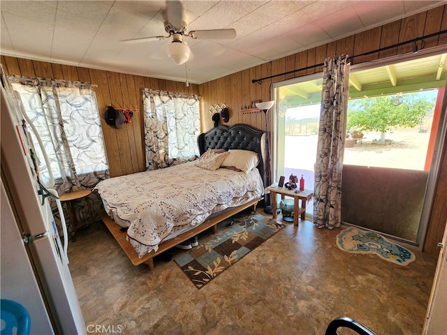 bedroom with wood walls and ceiling fan