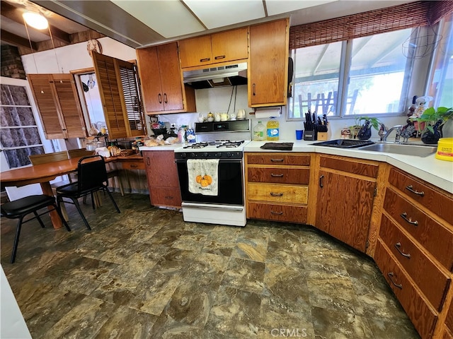 kitchen with white range with gas stovetop, beam ceiling, and sink