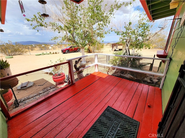 wooden deck with a mountain view