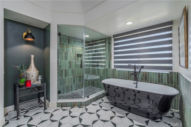 bathroom featuring shower with separate bathtub