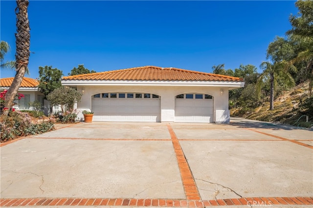 mediterranean / spanish house with a garage